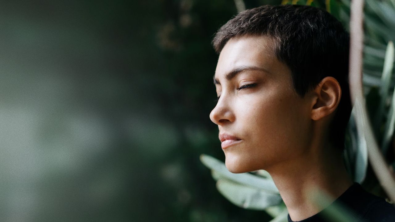 woman with her eyes closed, relaxing